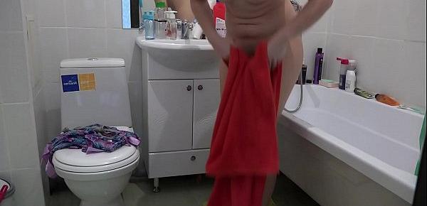  Brunette with a juicy ass in the bathroom is washed and masturbates with a stream of water and with a dildo.